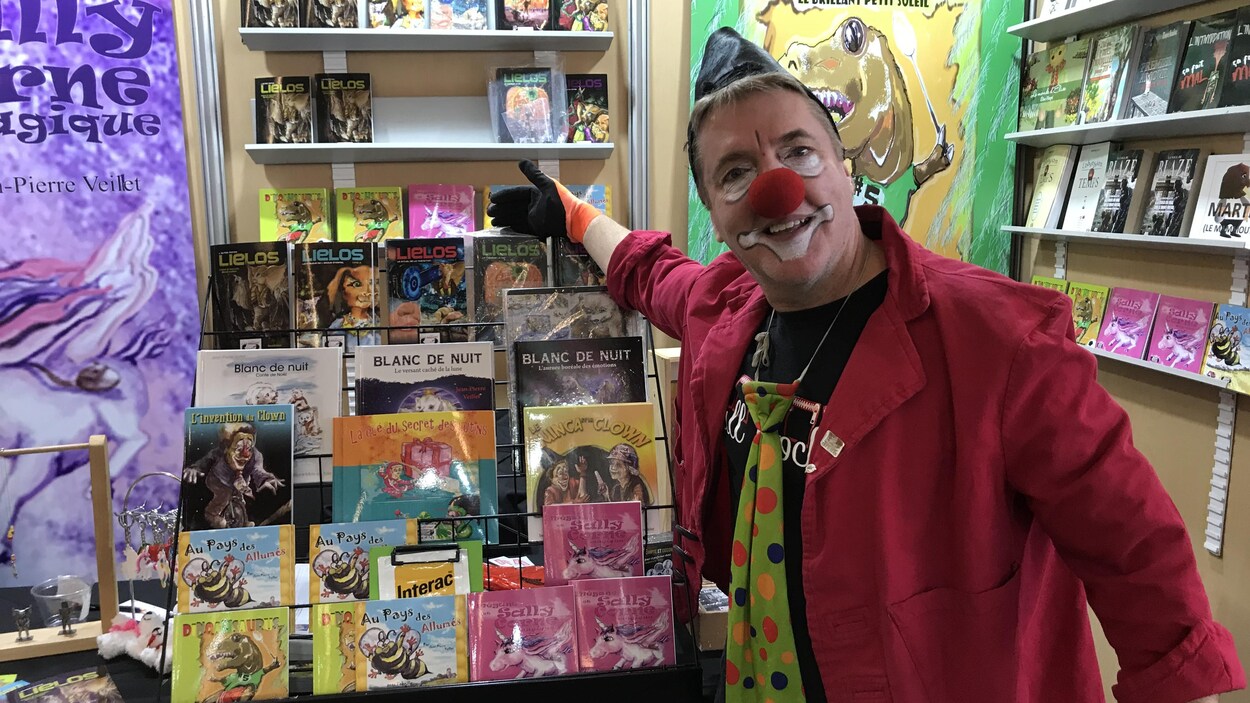Un clown montre des livres.