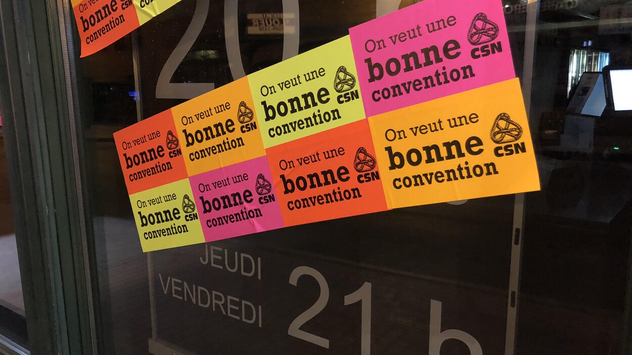 Des autocollants pour exiger une « bonne convention » sur la façade de la succursale de la SAQ sur la rue Saint-Jean. Des autocollants pour exiger une « bonne convention » sur la façade de la succursale de la SAQ sur la rue Saint-Jean.