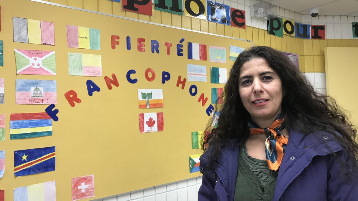 Siham El Aoufir devant un tableau sur lequel il est écrit « fierté francophone ».