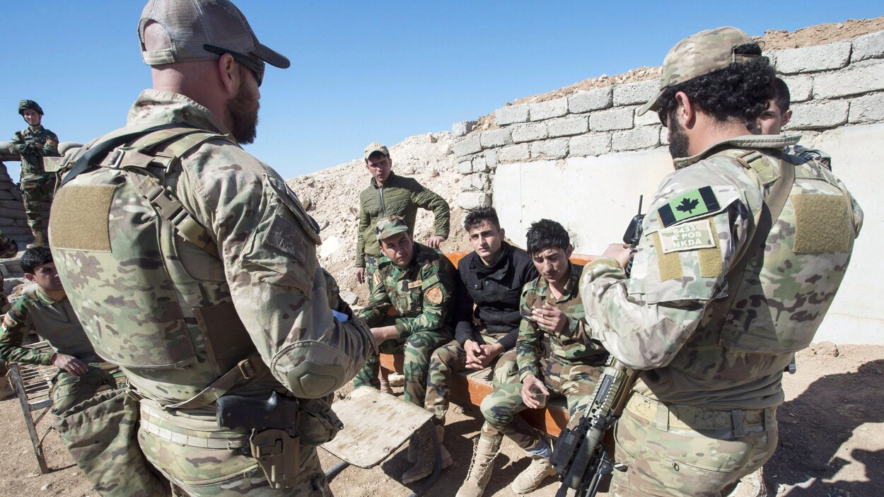 Des soldats canadiens parlent avec des combattants dans un poste d’observation situé dans le nord de l’Irak.