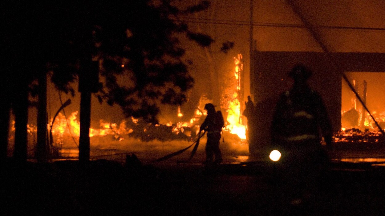 Des pompiers qui tentent d'éteindre les flammes. Des pompiers qui tentent d'éteindre les flammes.