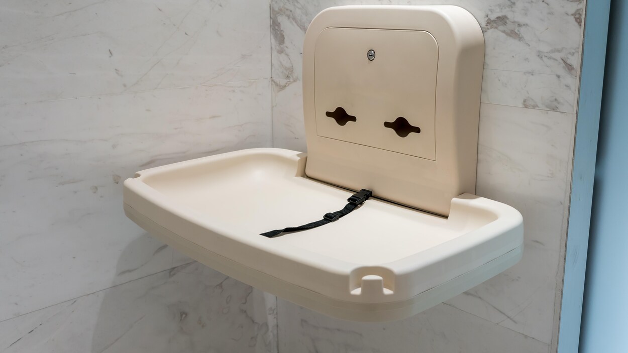 Une table à langer dans une toilette publique