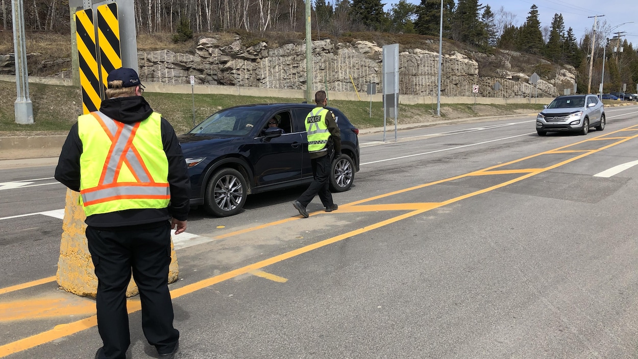 Un policier questionne un automobiliste.