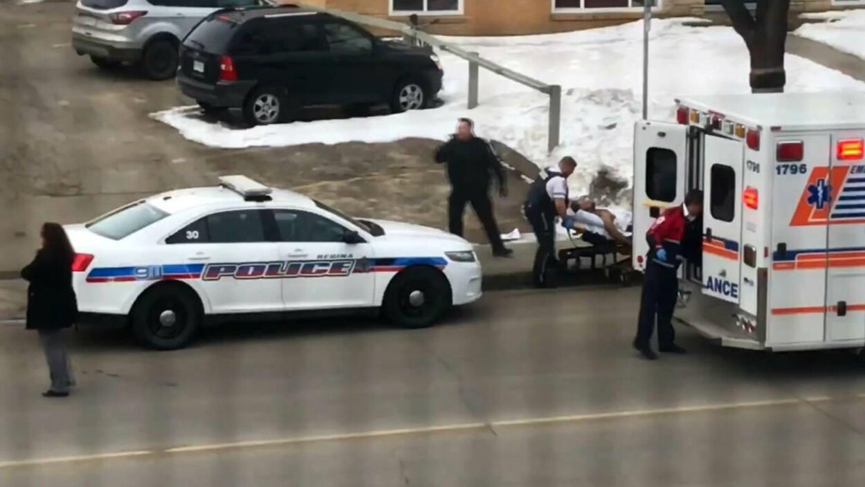 Le chauffeur de taxi blessé est allongé sur un brancard. Il s'apprête à être placé dans une ambulance avant son transport à l'hôpital. Le chauffeur de taxi blessé est allongé sur un brancard. Il s'apprête à être placé dans une ambulance avant son transport à l'hôpital.