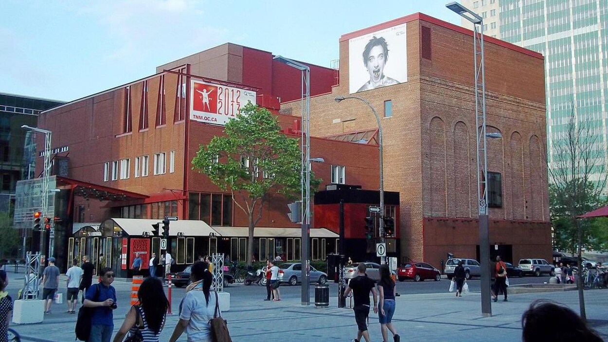 Le Théâtre du Nouveau Monde, dans la rue Sainte-Catherine, et des passants.