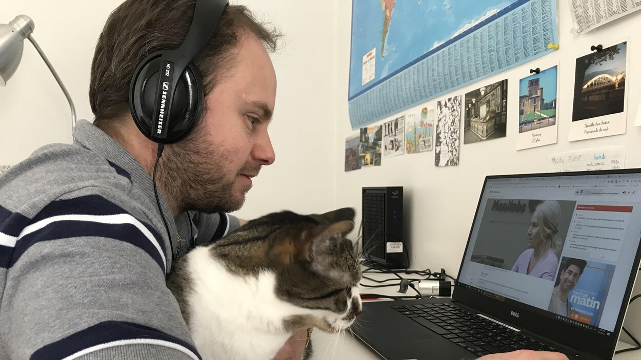 Thibault Jourdan et son chat devant un ordinateur.