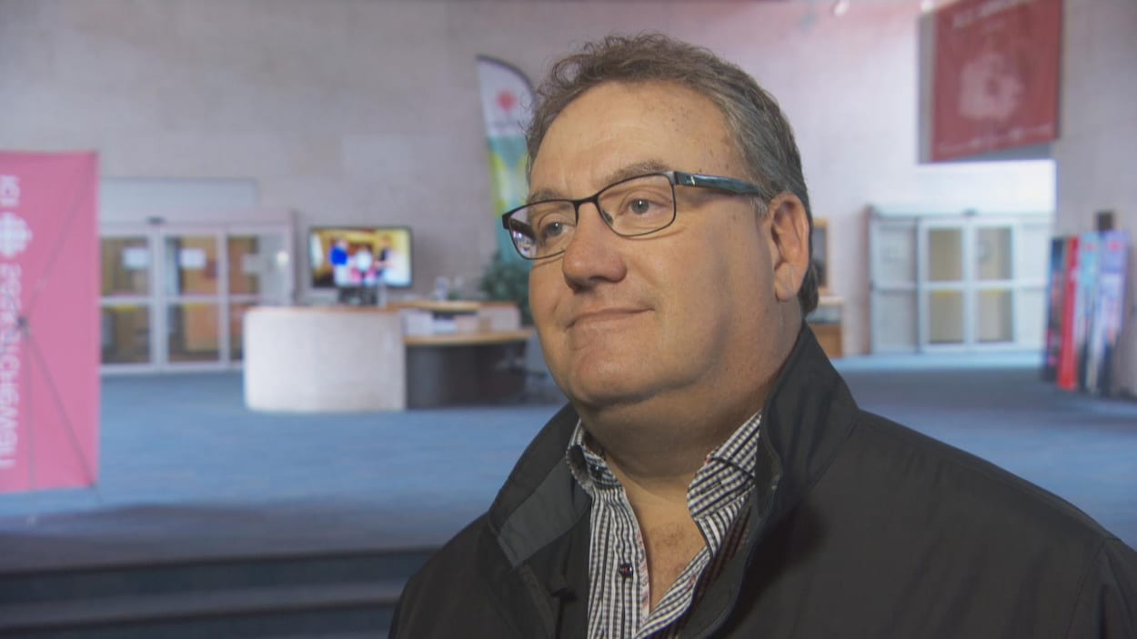 Todd Lewis donnne une entrevue debout dans le hall d'entrée de l'édifice de Radio-Canada à Regina.