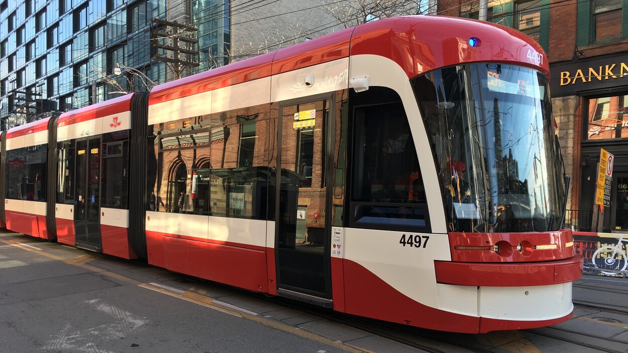 Photo d'un tramway rouge et blanc dans la rue