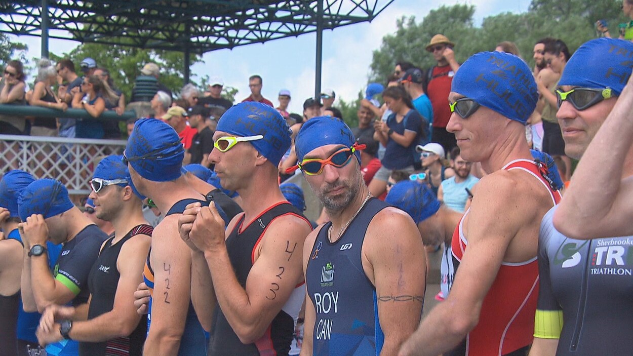 Une dizaine d'hommes, vêtue de leurs maillots de bain, casques et lunettes de natation, se prépare