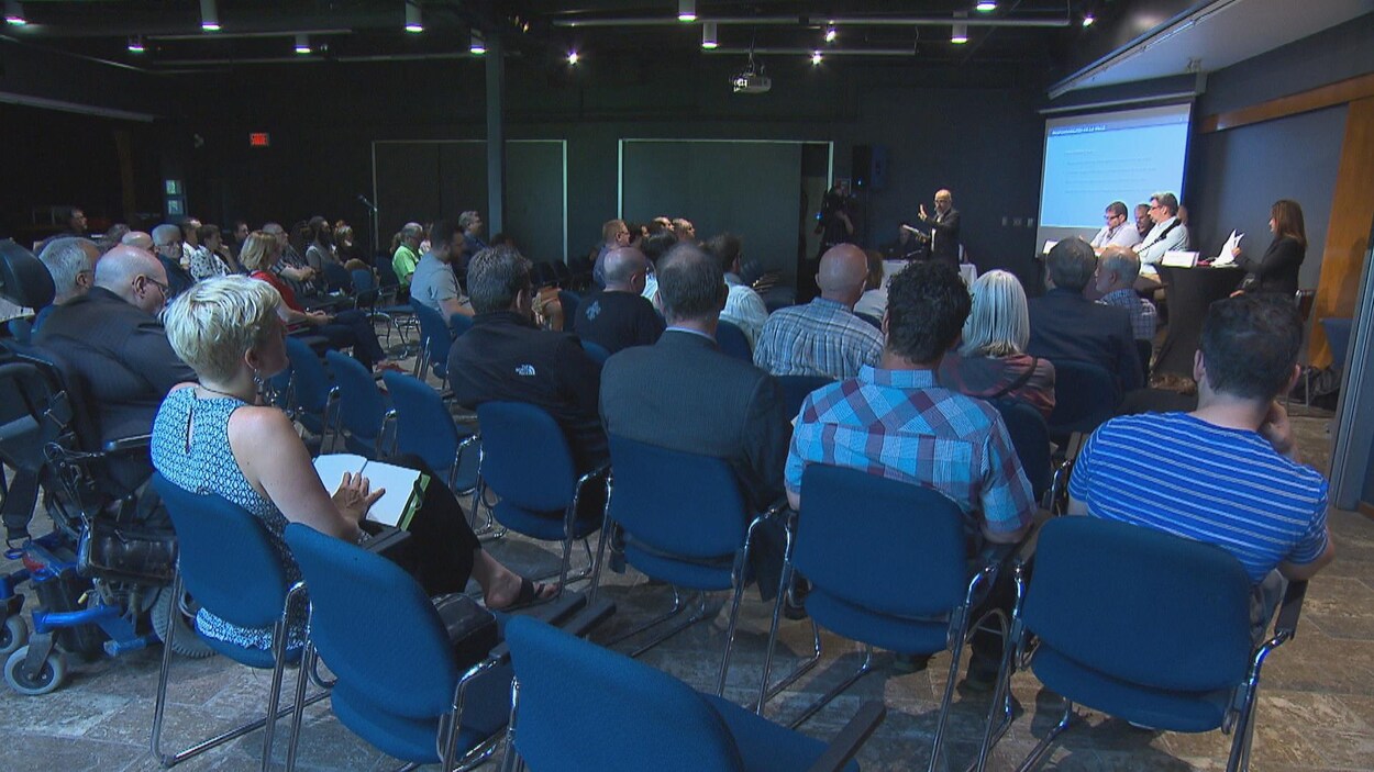 Des citoyens assis qui participent à une rencontre d'information sur le quartier Well sud.