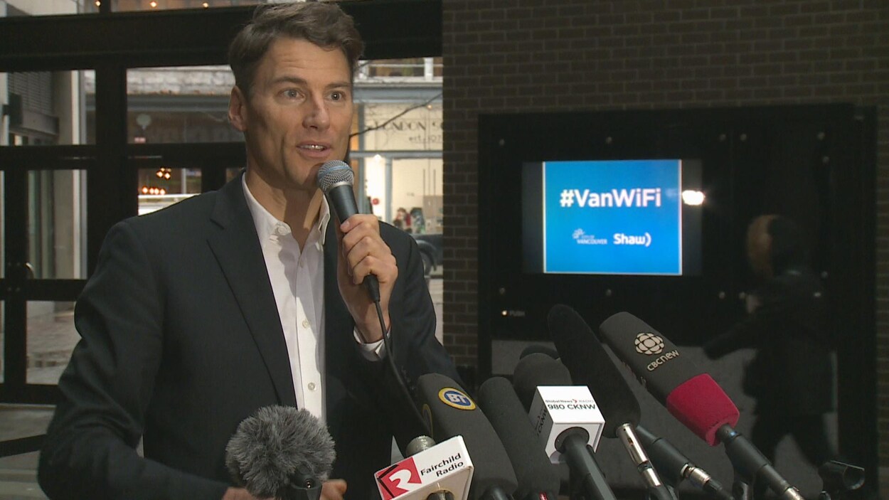 Le maire de Vancouver tenant un micro Le maire de Vancouver tenant un micro