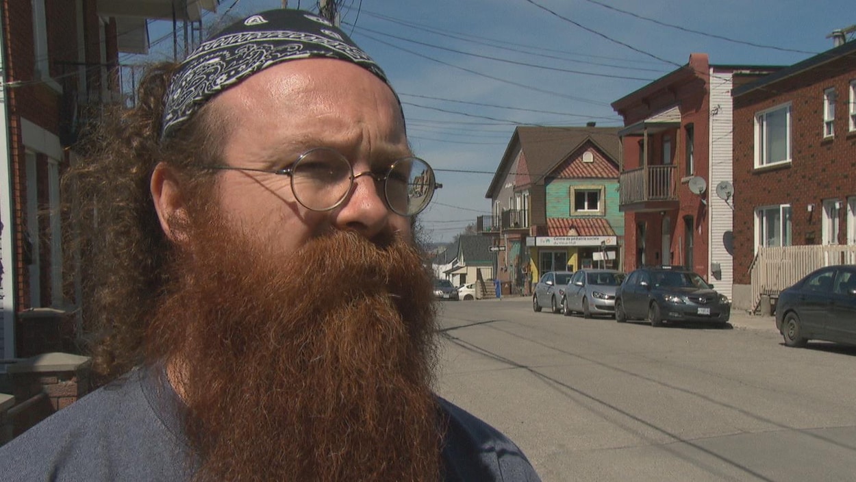 L'homme est interviewé sur le trottoir devant les locaux de l'organisme dans le Vieux-Hull.