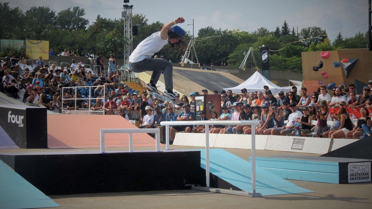 Elle saute avec sa planche à roulettes.