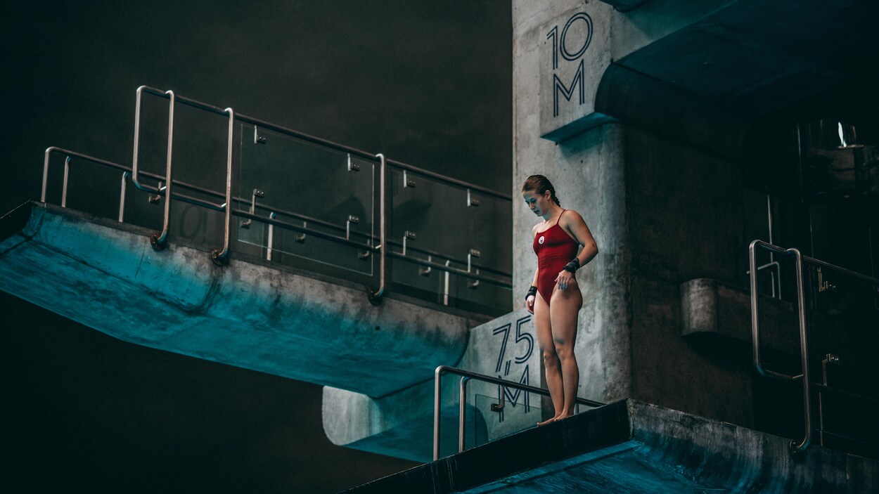 Postée sur la tour de 10 mètres, la plongeuse Caeli McKay regarde en bas en direction du bassin. Postée sur la tour de 10 mètres, la plongeuse Caeli McKay regarde en bas en direction du bassin.