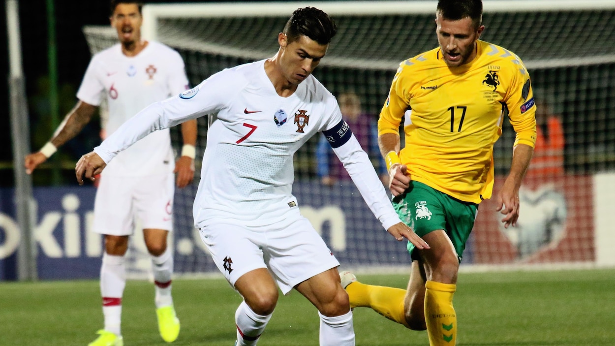 Cristiano Ronaldo, en possession du ballon, bataille avec Mantas Kuklys, de la Lituanie.