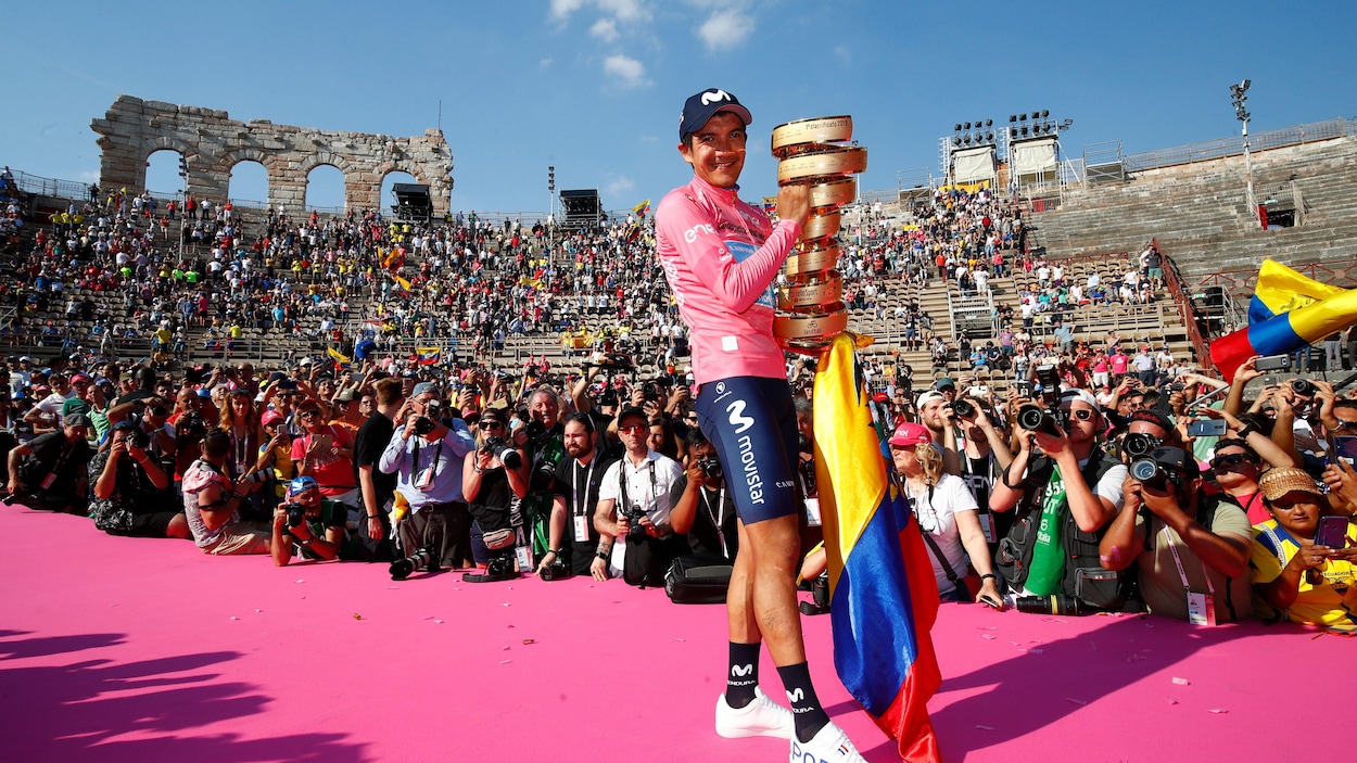 L'Équatorien Richard Carapaz célèbre sa victoire au Giro avec le trophée du vainqueur au milieu de l'amphithéâtre de Vérone.