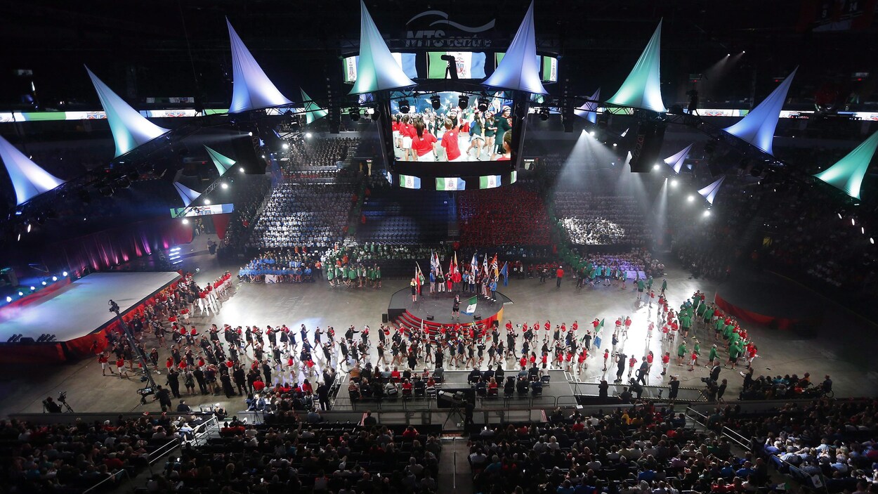Des jeunes défilent lors d'une cérémonie d'ouverture d'un événement sportif.
