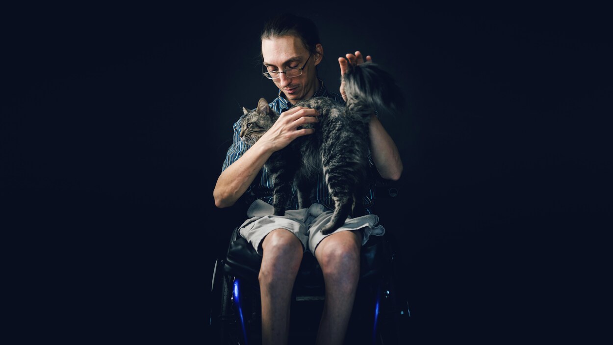 Marthieu Bédard tient se chat dans ses bras. Marthieu Bédard tient se chat dans ses bras.