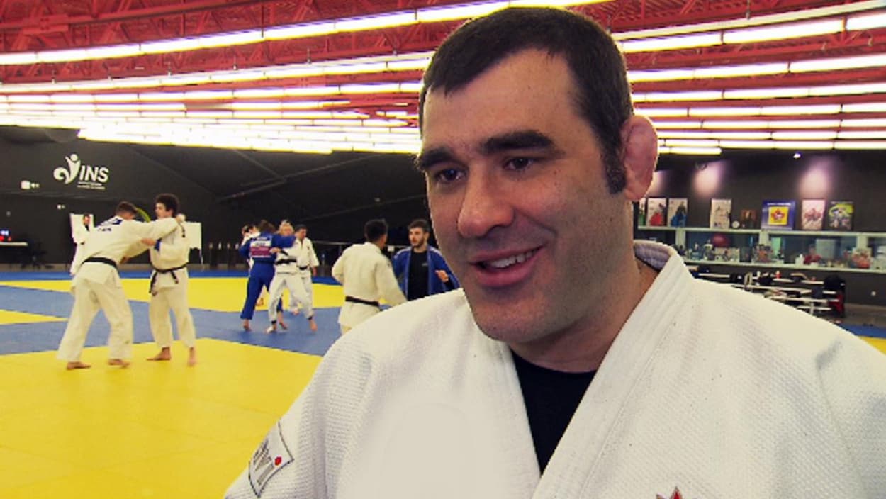 Gros plan de Nicolas Gill devant des tatamis.