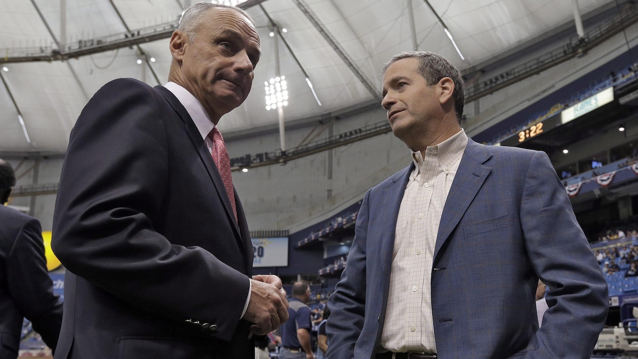 Le commissaire des ligues majeures et le propriétaire des Rays de Tampa Bay discutent avant un match de baseball au Tropicana Field.