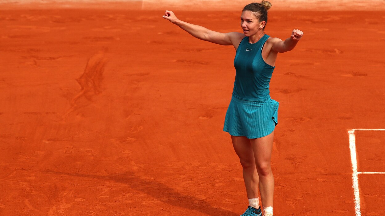 Simona Halep célèbre sa victoire en soulevant les bras tout en regardant la foule. Simona Halep célèbre sa victoire en soulevant les bras tout en regardant la foule.
