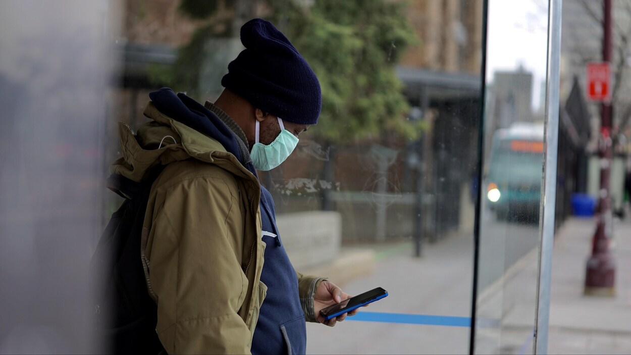L'homme porte un masque chirurgical.