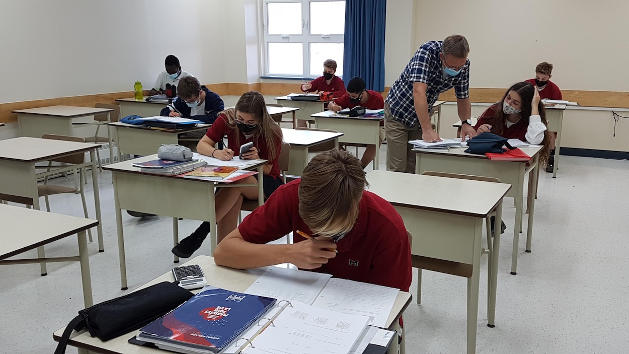 Des élèves portant des masques en classe dans une école secondaire.