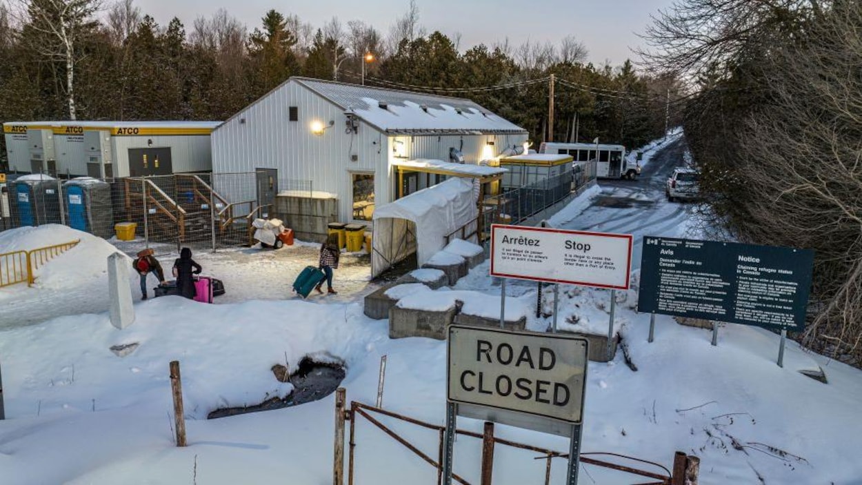 L'entrée du chemin Roxham aux frontières canadiennes et des migrants avec leurs bagages.