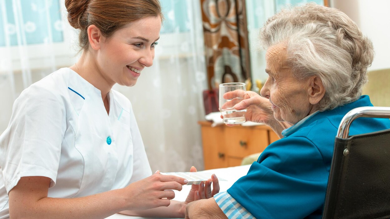 Une femme prodigue des soins à une patiente.