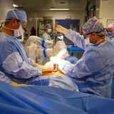 Un equipo quirúrgico del Centro de Ciencias de la Salud Queen Elizabeth II utiliza un brazo robótico para la cirugía de la columna vertebral. 