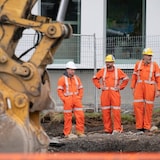 Workers oversee a construction site in Montreal on Aug. 20, 2024. 