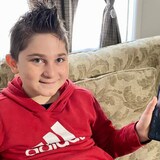 From his Saskatoon home, nine-year-old Adnan Kharsa speaks to his father in Turkey over video chat. The Syrian refugee hasn't seen his parents in person since 2017. (Bonnie Allen/CBC)