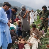 Civil defence workers, locals and army soldiers in Mazar Dara, Kunar province, prepare to evacuate injured people after an earthquake that hit late Sunday, killing hundreds and destroying numerous villages in eastern Afghanistan. 