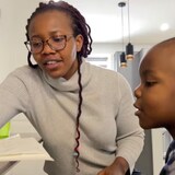 Chinwe Achebe and her three-year-old son, Chukwudum, practice math at their home in Calgary. (Dan McGarvey/CBC)