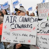 Air Canada employees holding signs at a protest.