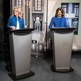 Rachel Notley, left, leader of the New Democratic Party in Alberta, and United Conservative Party Leader Danielle Smith prepare for a debate during the election campaign. Both have said they are ready to stand up to the federal government. (Jason Franson/The Canadian Press)
