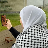 A woman speaks with a man over video call.