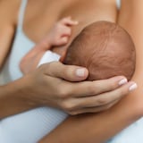 A woman breastfeeding a baby.