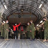 Defence Minister Anita Anand speaks with Canadian military personnel onboard a transport plane during a visit to highlight military aid for Ukraine at Canadian Forces Base Trenton in Trenton, Ont., April 14, 2022.