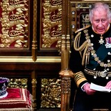 Prince Charles reads the Queen's speech as he sits by the The Imperial State Crown in the House of Lords Chamber during the State Opening of Parliament in London on Tuesday, May 10, 2022. (Ben Stansall/The Associated Press)