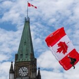 A skydiver glides beside the Peace tower during Canada Day events in Ottawa in 2022. Private members' bills may have their best effects when they're ambitious. (Lars Hagberg/The Canadian Press/The Associated Press)