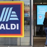 A shopper enters an Aldi supermarket near Altrincham, Britain, in February 2023. The German chain is among several European grocers that the federal government is reportedly courting to enter the Canadian market. 