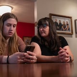 Emma Parsons scrolls through old messages on her phone that she received from an ex with her mother, Carmen. After the Ottawa nursing student blocked her ex on all platforms, she says he started contacting her by sending abusive messages attached to banking e-transfers. 