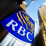 Royal Bank sign in front of two very tall buildings.
