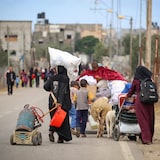 Palestinians evacuate the area targeted by Israel in Rafah.