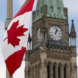 A Canadian flag hangs from a lamp post along the road in front of the Parliament buildings ahead of Canada Day in Ottawa,  Tuesday, June 30, 2020. Celebrations on Parliament Hill were cancelled this year due to the COVID-19 pandemic. THE CANADIAN PRESS/Adrian Wyld