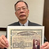 Members of Roddy Chung’s family paid the head tax for immigrating to Canada in the early twentieth century. He holds the certificates that belonged to his aunt and uncle, proof they paid $500 each. (Paula Dayan-Perez/CBC)