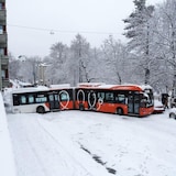 A bus in a snowy street. 
