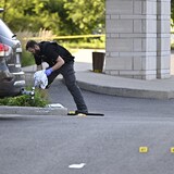 Evidence markers are seen in the convention centre's parking lot on Sept. 3, the day after the attack. 