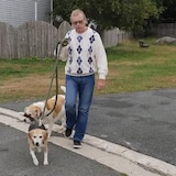 George Martin, 68, walks two of his four beagles outside his home in Mount Pearl, N.L., an activity he wasn't able to do before receiving remote deep brain stimulation treatment. (Submitted by George Martin)